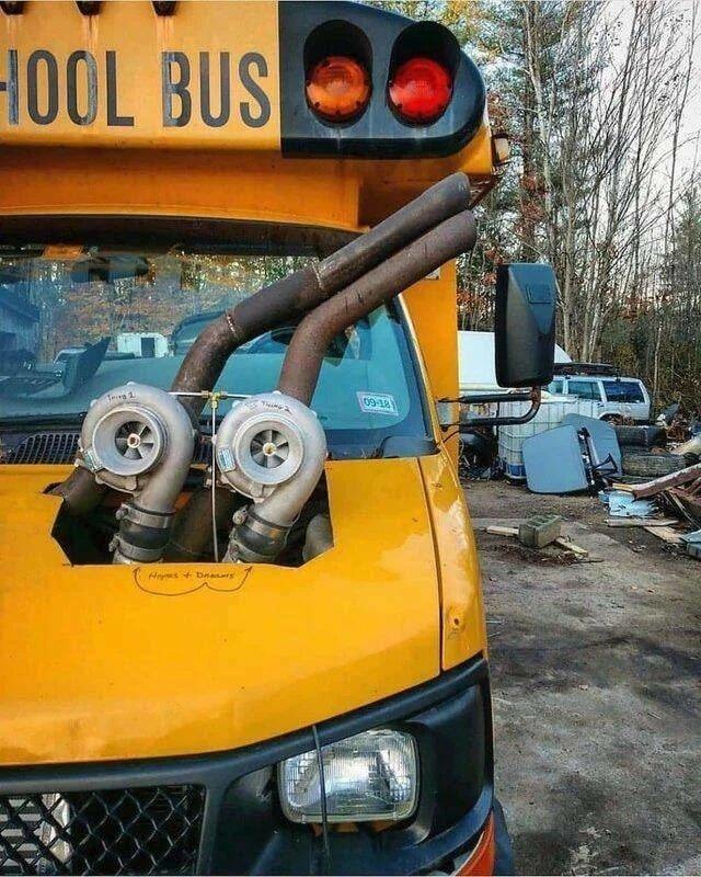 SCHOOL BUS
Two large turbochargers mounted in the engine bay of a yellow school bus.