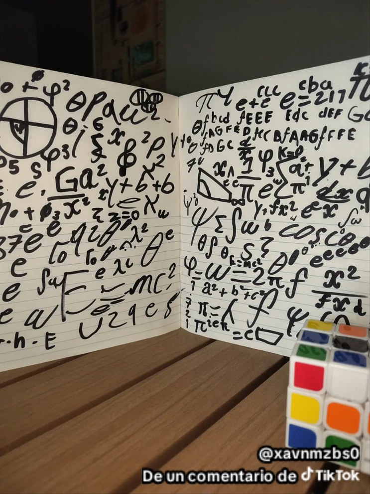 Una pared llena de garabatos y símbolos extraños en color negro; esquina con un cubo Rubik en la mesa.