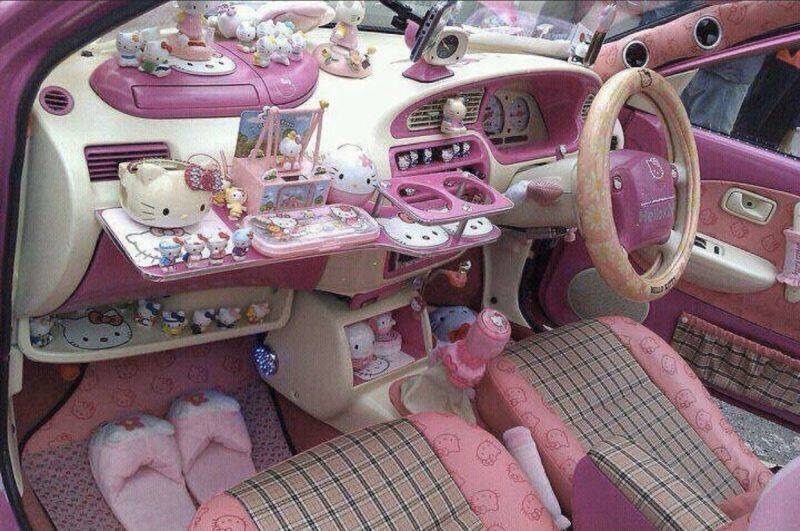 Pink toy car interior with various pink decor and miniature items.