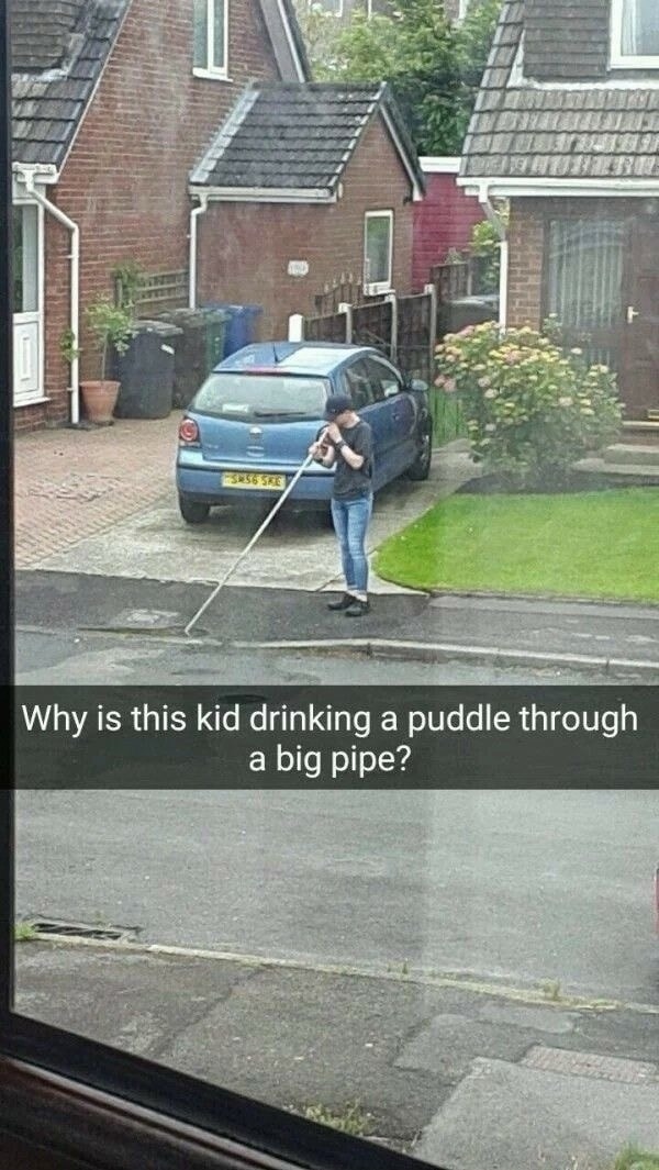 Why is this kid drinking a puddle through a big pipe?