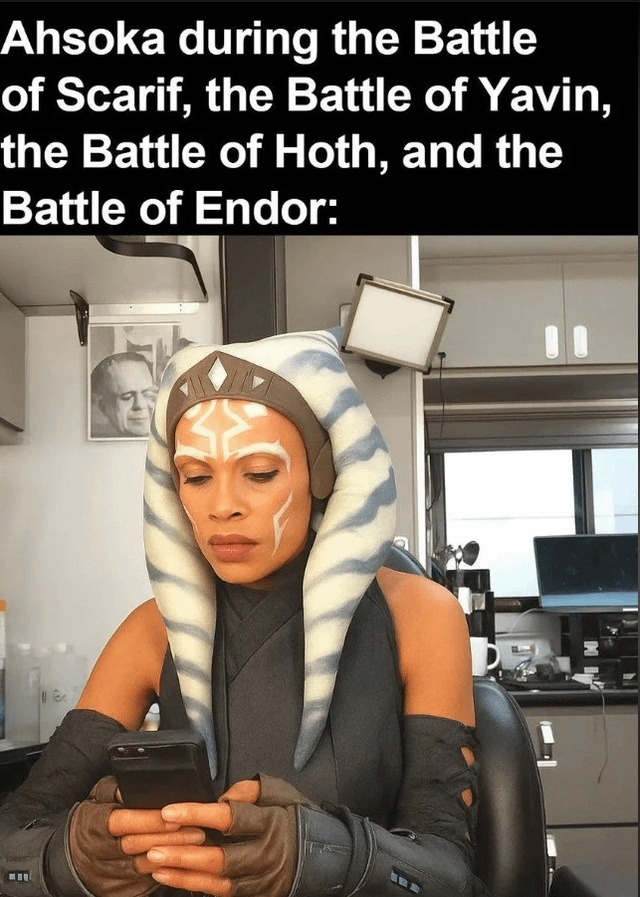 Ahsoka during the Battle of Scarif, the Battle of Yavin, the Battle of Hoth, and the Battle of Endor: A woman dressed as Ahsoka Tano from Star Wars is looking at her phone, implying she was not involved in the listed battles.
