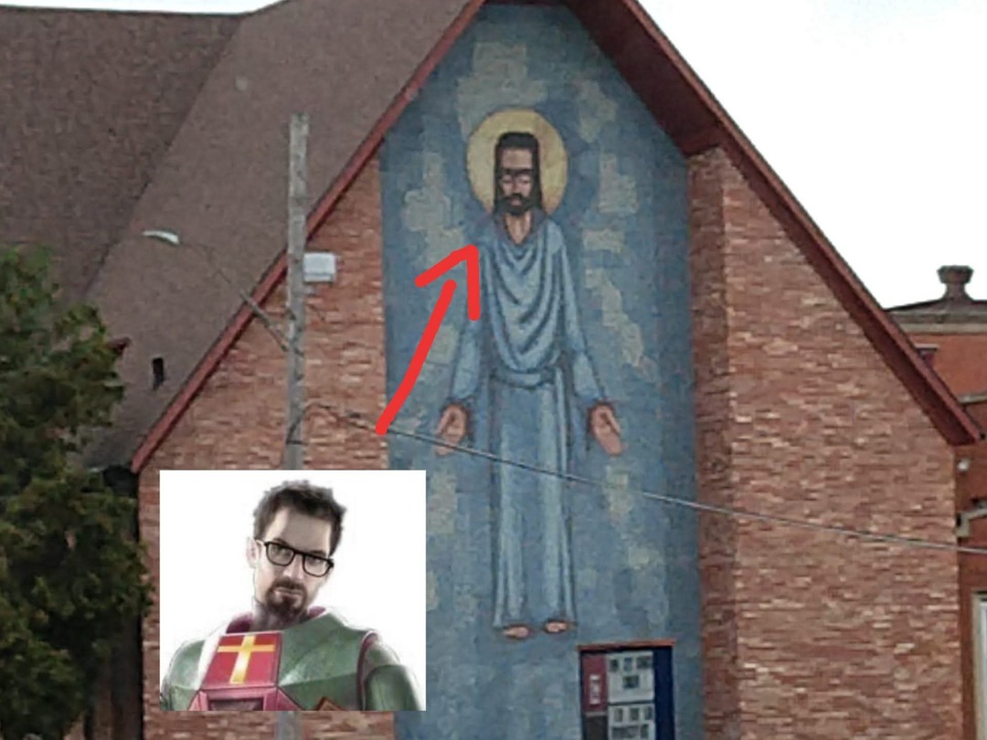 Mural de Jesús con gafas en un edificio, con una imagen de Gordon Freeman y una flecha señalando la similitud.