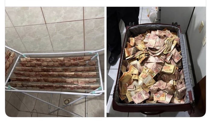 Notas de dinheiro brasileiro (reais) secando em um varal e uma mala cheia de dinheiro. As notas parecem estar molhadas ou recém-lavadas, com valores de R$10, R$20, R$50 e R$100 visíveis.