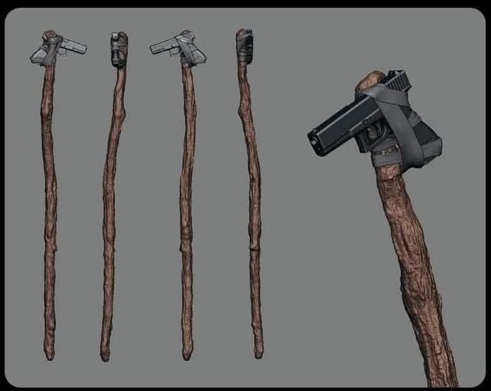 Un bastón de madera con una pistola atada en la parte superior.