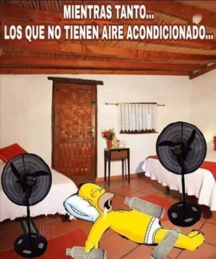 MIENTRAS TANTO... LOS QUE NO TIENEN AIRE ACONDICIONADO... Homer Simpson está tumbado en el suelo con botellas congeladas sobre su cuerpo y dos ventiladores soplando aire hacia él, intentando refrescarse del calor.