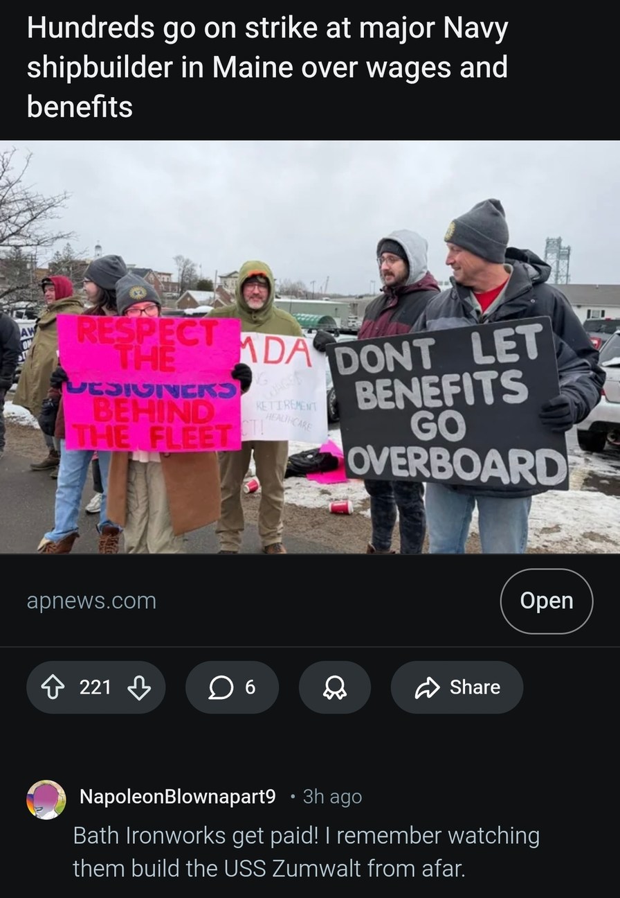 Hundreds go on strike at major Navy shipbuilder in Maine over wages and benefits. Signs read: 'RESPECT THE DESIGNERS BEHIND THE FLEET', 'MDA', 'WAGES', 'RETIREMENT', 'HEALTHCARE', 'RESPECT!', 'DON'T LET BENEFITS GO OVERBOARD'. A user comment states: 'Bath Ironworks get paid! I remember watching them build the USS Zumwalt from afar.'