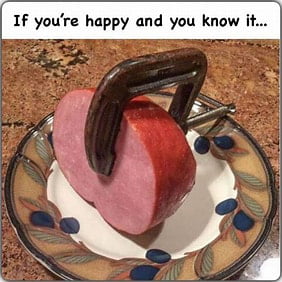 If you're happy and you know it... A piece of ham is clamped on a plate, creating a visual pun on 'clap your hands'.