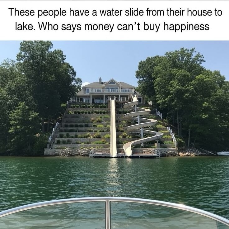 These people have a water slide from their house to lake. Who says money can't buy happiness