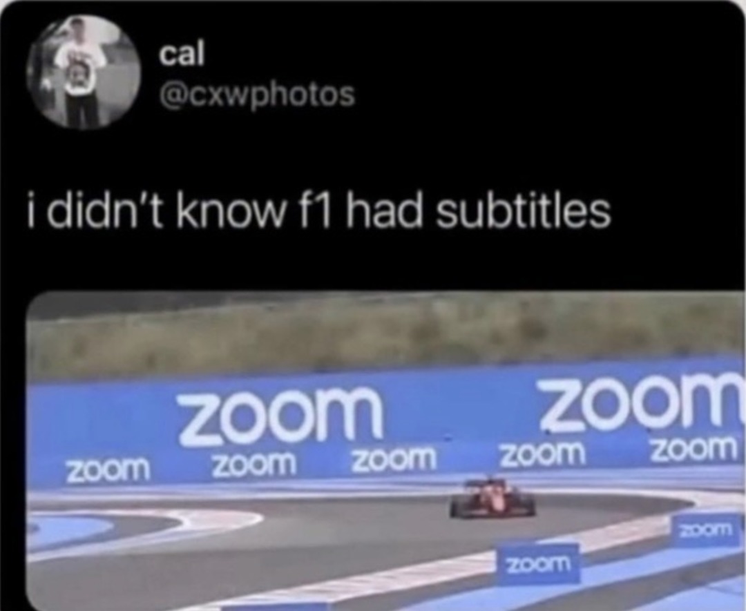 i didn't know f1 had subtitles. The image shows a tweet with this text, and below it, an F1 race track with 'zoom' logos on the barriers and trackside blocks.