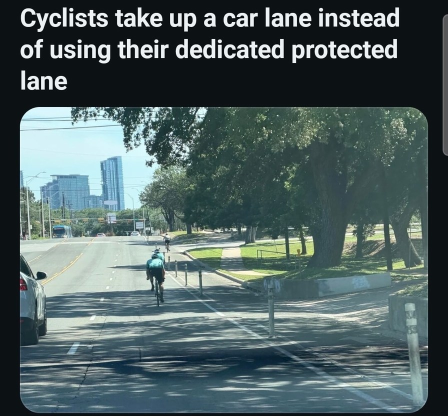 Cyclists take up a car lane instead of using their dedicated protected lane