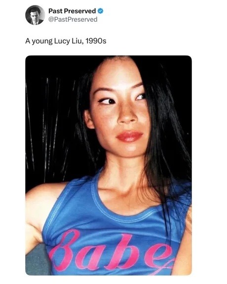 Past Preserved @PastPreserved A young Lucy Liu, 1990s. The woman in the image is wearing a blue top with the word 'Babe' written on it.