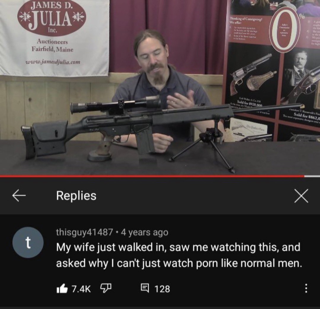A man is presenting a rifle with a scope and bipod on a table, likely discussing it for an auction or review. In the background, there are banners for James D. Julia Auctioneers, showing antique firearms and auction results. A YouTube comment reads: 'My wife just walked in, saw me watching this, and asked why I can't just watch porn like normal men